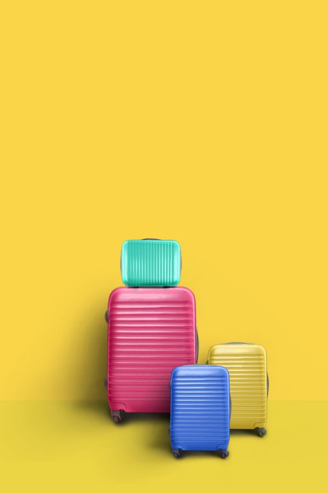 Close-Up Of Suitcase Against Yellow Background