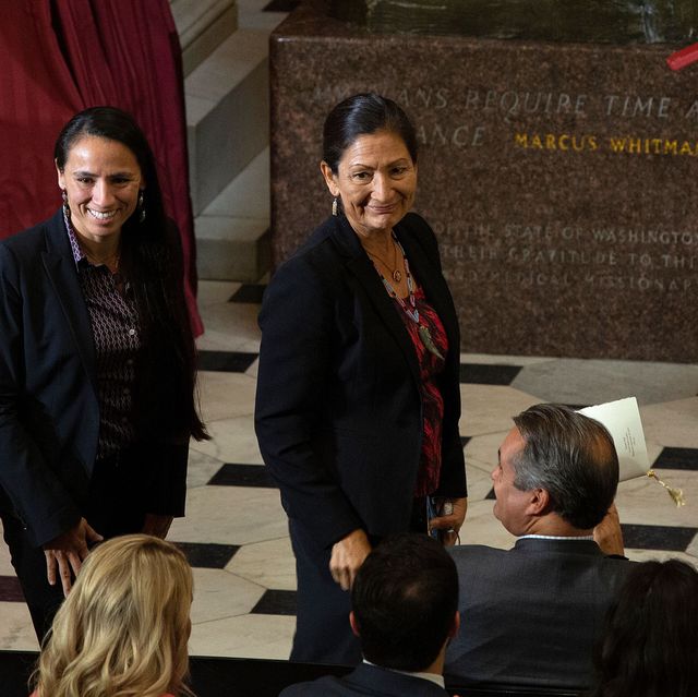 us representatives sharice davids l and deb haaland stand to people clapping as they are recognized as the first native american women elected to congress during a dedication and unveiling ceremony for a statue of ponca chief standing bear of nebraska in statuary hall on capitol hill in washington, dc, on september 18, 2019 photo by alastair pike  afp        photo credit should read alastair pikeafp via getty images