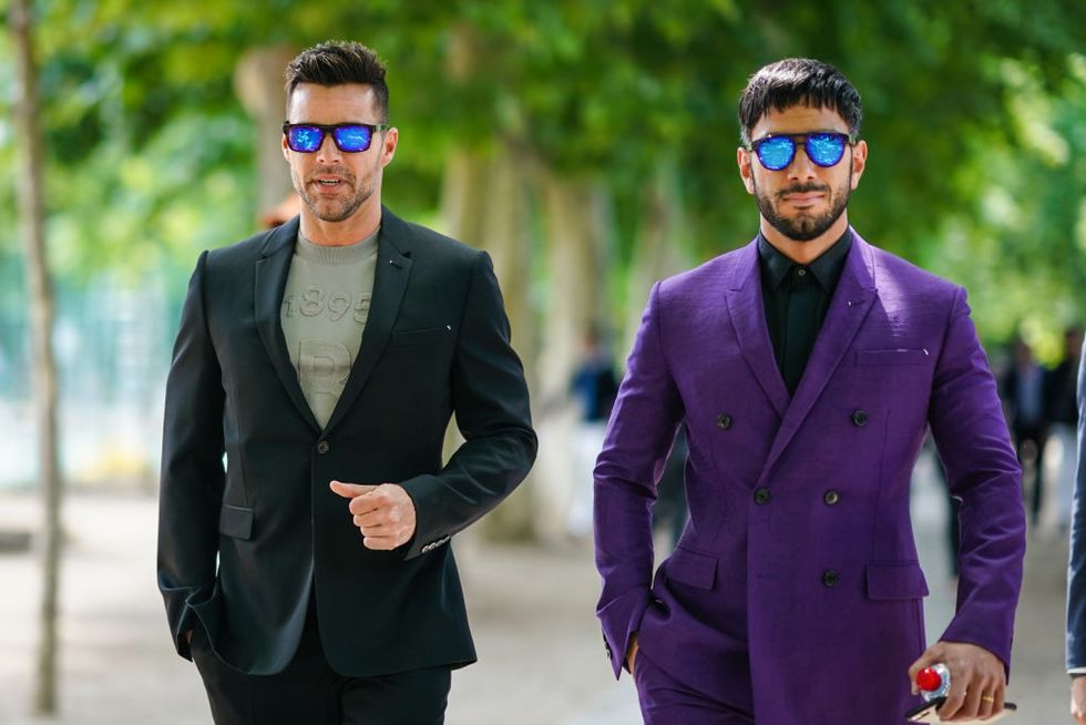 paris, france june 21 ricky martin l wears blue mirrored sunglasses, an almond green top, a dark green suit jwan yosef r wears blue mirrored sunglasses, a black shirt, a purple double breasted suit, outside berluti, during paris fashion week menswear springsummer 2020, on june 21, 2019 in paris, france photo by edward berthelotgetty images