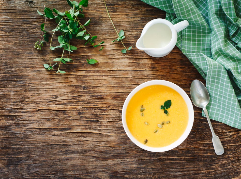 pumpkin creamy soup on dark wooden background top view