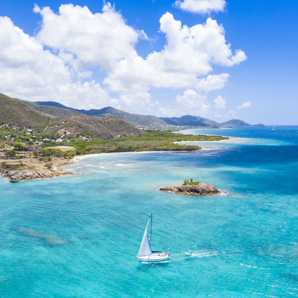 aerial view of boat sailing in the turquoise caribbean sea, urlings, antigua, antigua and barbuda, caribbean, west indies