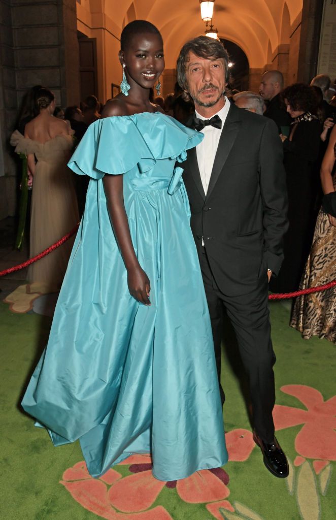 milan, italy   september 22   adut akech  wearing valentino and valentino creative director pierpaolo piccioli attend the green carpet fashion awards, italia 2019, hosted by cnmi  eco age, at teatro alla scala on september 22, 2019 in milan, italy  photo by david m benettdave benettgetty images for eco age ltd