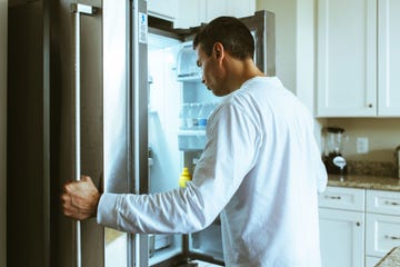 a man opening a refrigerator