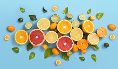 sliced various citrus fruits on blue background