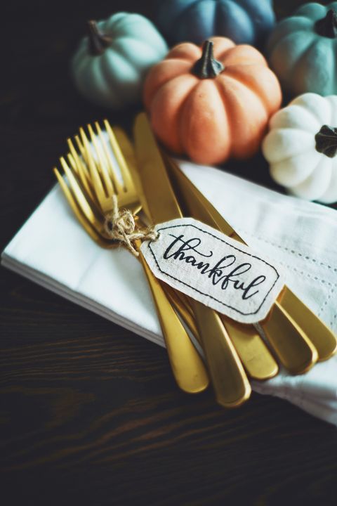 thanksgiving table setting background with pumpkins and gold cutlery