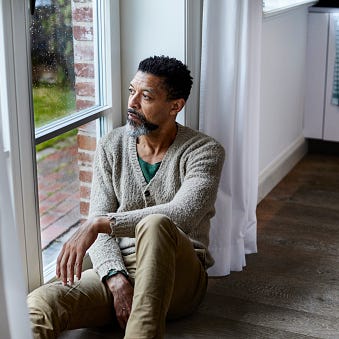 man sitting looking out the window