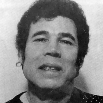 mug shot of a man with curly hair