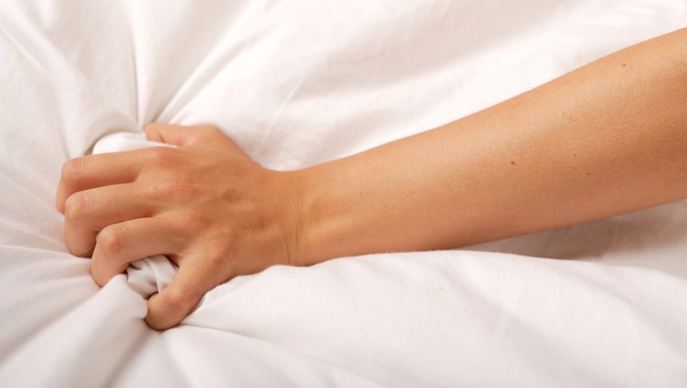hand grabbing onto a white sheet