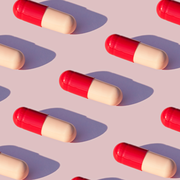 red and pink pills on lavender background