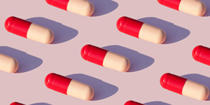 red and pink pills on lavender background