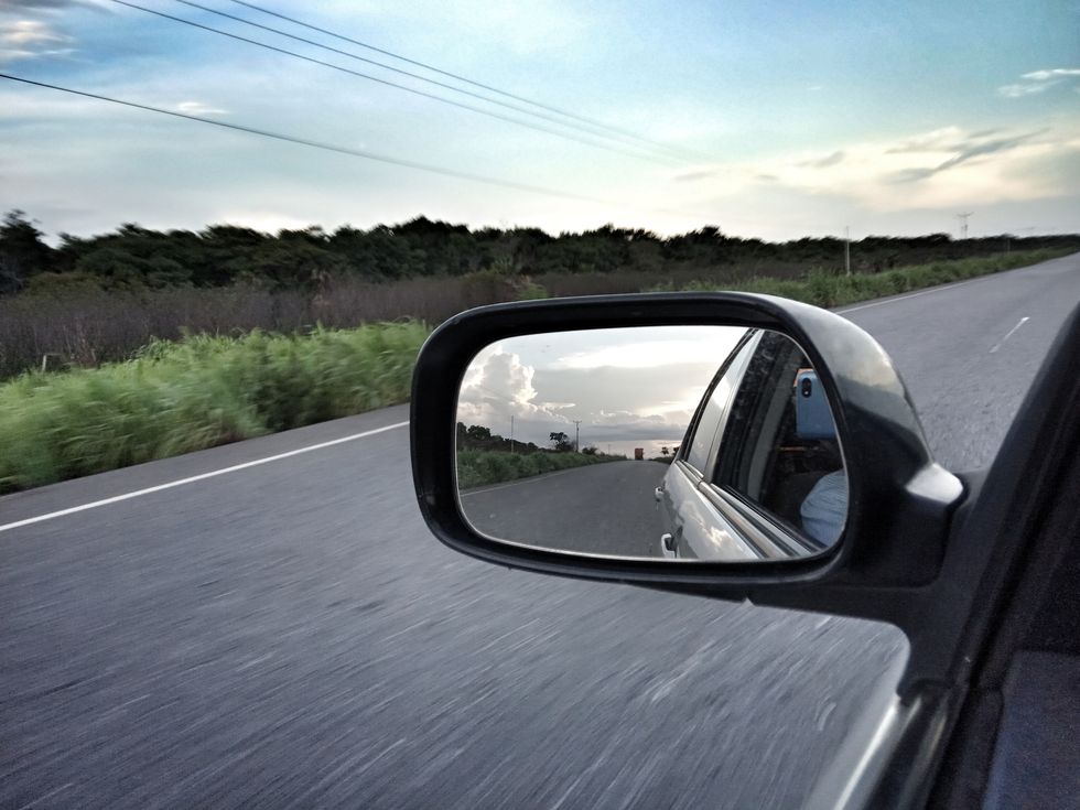 guarico state, venezuela jul 17 view of the road reflected in wing mirror, on july 17, 2019