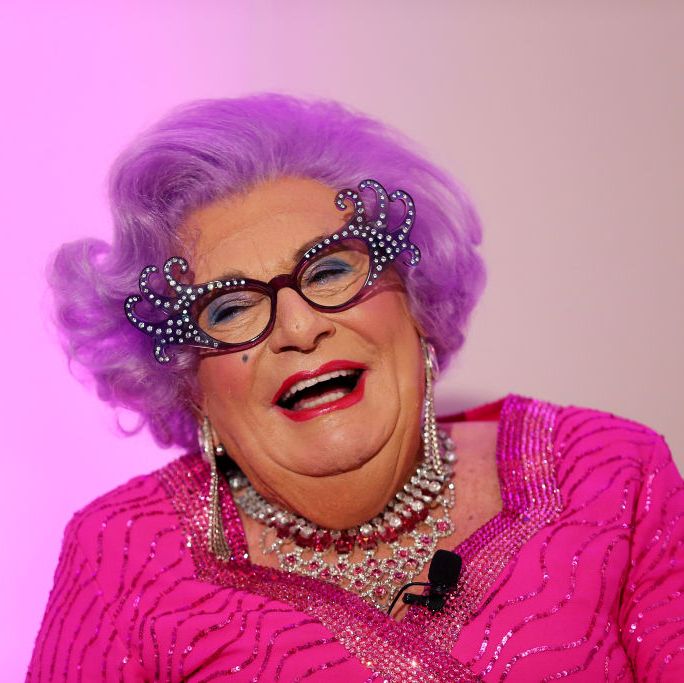 barry humphries as dame edna everage poses during a high tea launch, wearing all pink with funky sunglasses