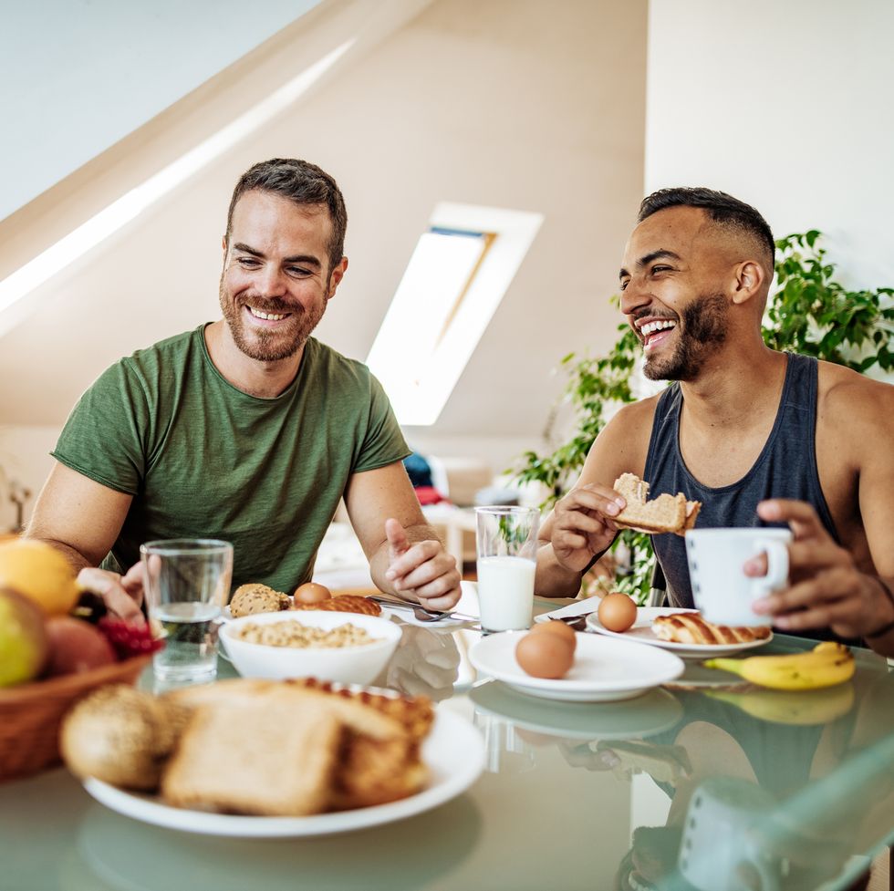 gay couple having breakfast at home