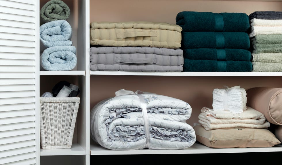 neatly organized shelves containing various towels and bedding items