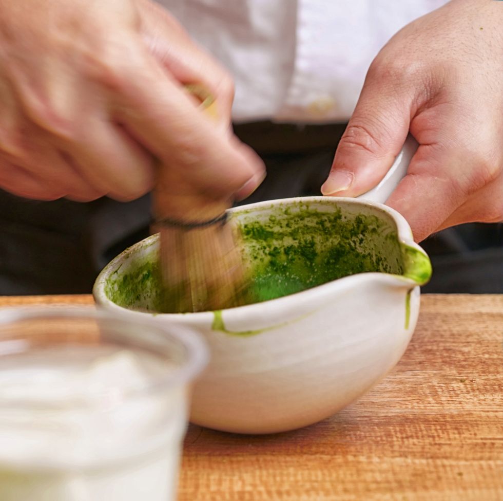 Close up of the traditional way of preparing green tea for macha latte, Japanese tea ceremony, Osaka.