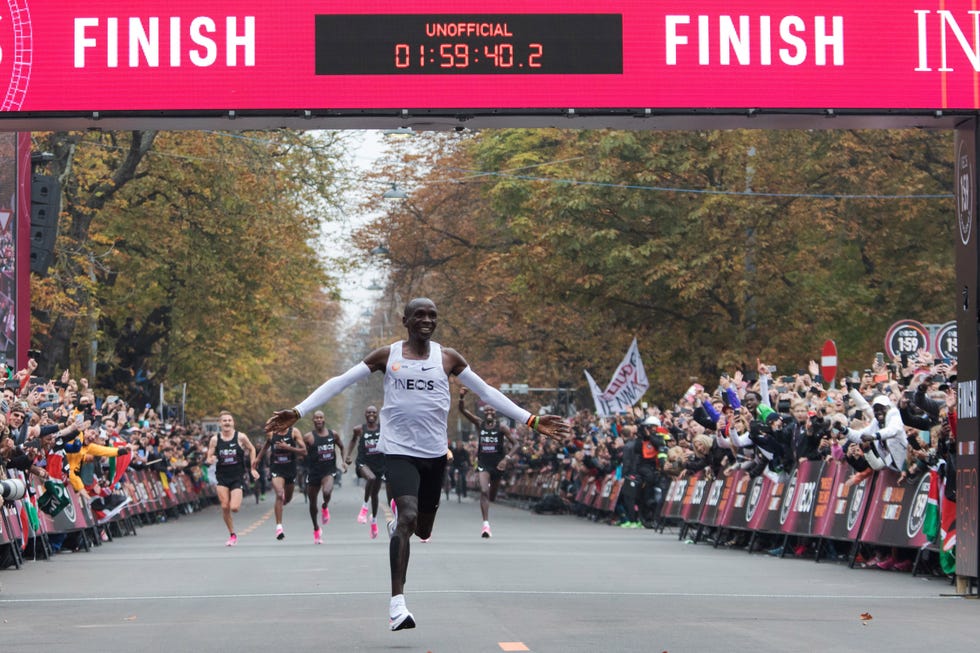 topshot kenyas eliud kipchoge white jersey celebrates as he crosses the finish line at the end of his attempt to bust the mythical two hour barrier for the marathon on october 12 2019 in vienna kenyas eliud kipchoge on saturday made history, busting the mythical two hour barrier for the marathon on a specially prepared course in a huge vienna park with an unofficial time of 1hr 59min 402sec, the olympic champion became the first ever to run a marathon in under two hours in the prater park with the course readied to make it as even as possible photo by alex halada  afp photo by alex haladaafp via getty images