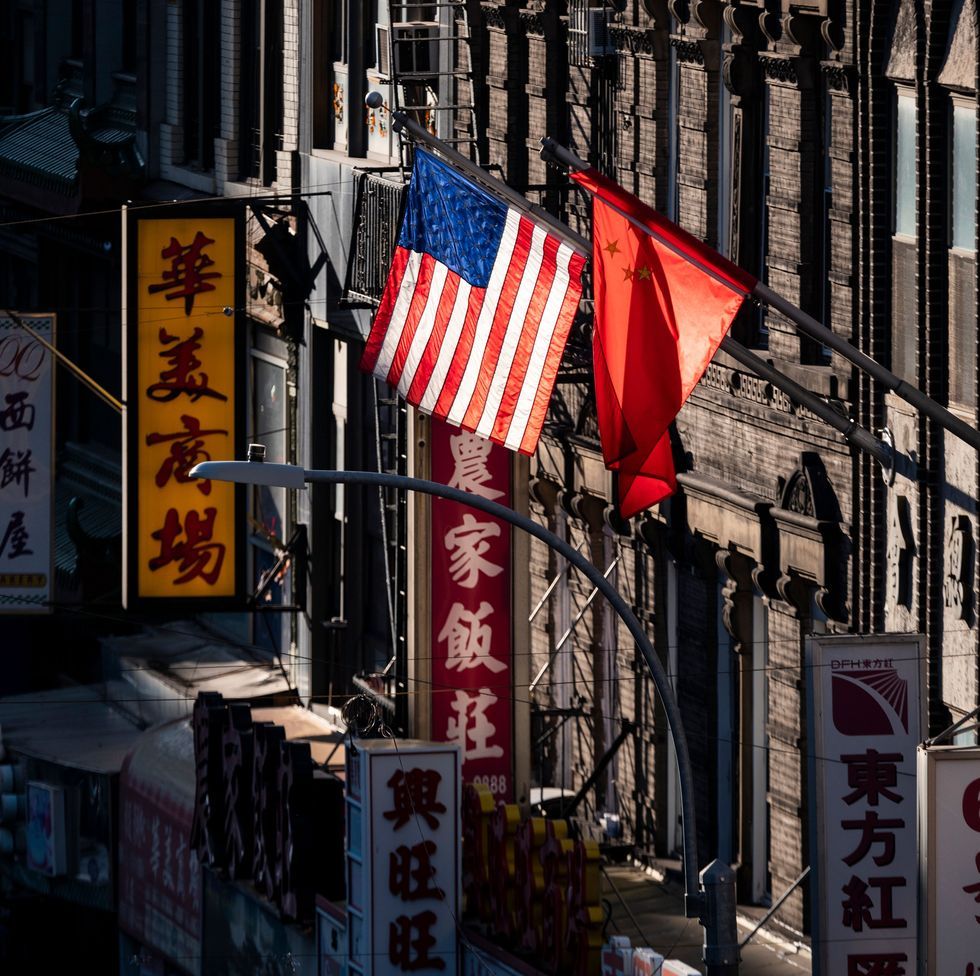 topshot   a us and chinese flag are seen in chinatown on october 14, 2019 in new york city photo by johannes eisele  afp photo by johannes eiseleafp via getty images