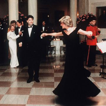 washington, dc   november 09 diana, princess of wales, wearing a midnight blue velvet, off the shoulder evening gown designed by victor edelstein, is watched by us president ronald reagan and first lady nancy reagan, as she dances with john travolta at the white house on november 9, 1985 in washington, dc photo by anwar hussein wireimage