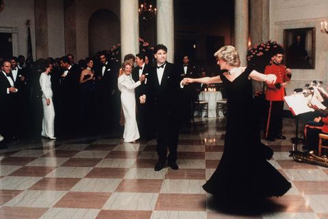 washington, dc   november 09 diana, princess of wales, wearing a midnight blue velvet, off the shoulder evening gown designed by victor edelstein, is watched by us president ronald reagan and first lady nancy reagan, as she dances with john travolta at the white house on november 9, 1985 in washington, dc photo by anwar hussein wireimage