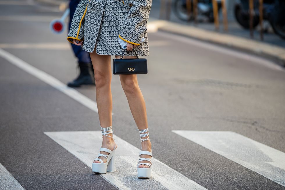milan, italy   september 21 yoyo cao is seen wearing jacket with print, black mini bag, high plateau heels outside the ferragamo show during milan fashion week springsummer 2020 on september 21, 2019 in milan, italy photo by christian vieriggetty images