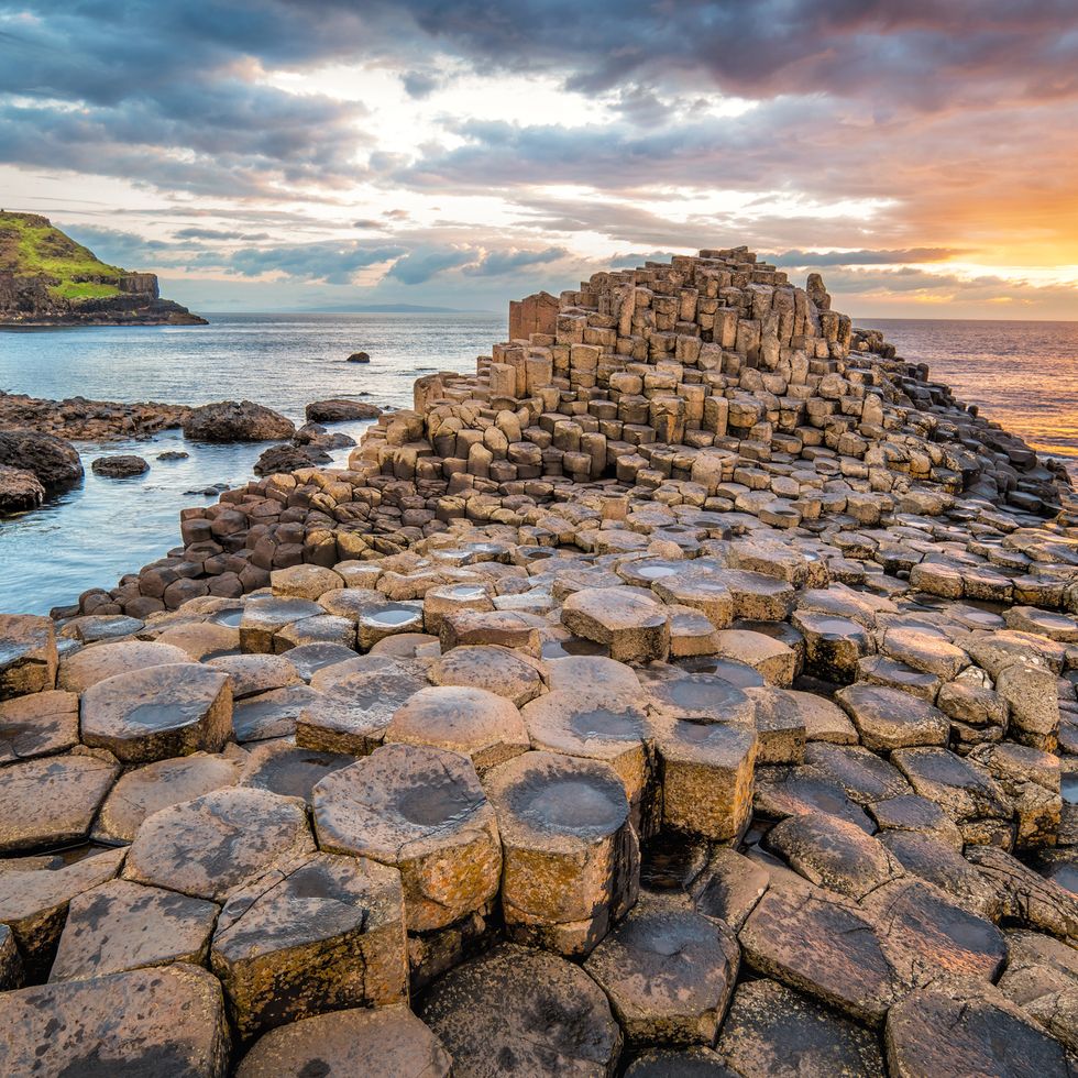 stock photograph of a dramatic sunset at the giants causeway in northern ireland, uk