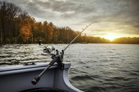 fishing rod on the boat, sunset time beautiful autumn colors a fishing rod is a long, flexible rod used by fishermen to catch fish