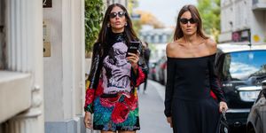 paris, france   september 29 gilda ambrosio seen wearing dress with graphic print and giorgia tordini wearing black off shoulder dress, black bag outside valentino during paris fashion week womenswear spring summer 2020 on september 29, 2019 in paris, france photo by christian vieriggetty images