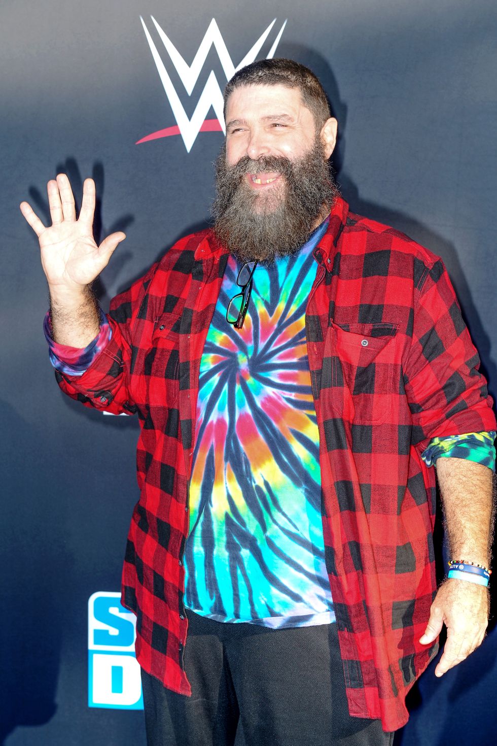 Mick Foley in 2019 wearing a tie-dye shirt like his character, Dude Love