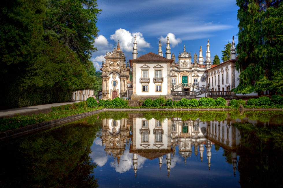 historic building with ornate architecture and reflections in a pond
