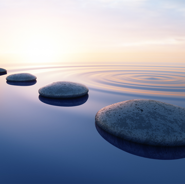 row of stones in calm water in ocean