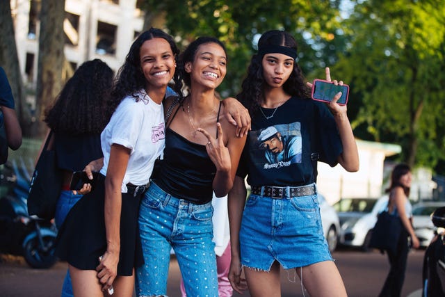 paris, france   june 29  models natalia montero, manuela sancehz, and rocio marconi throw peace signs after the miu miu resort 2020 show on june 29, 2019 in paris, france natalia wears a prada t shirt rocio wears a black headband, black snoop dog t shirt, and denim skirt photo by melodie jenggetty images