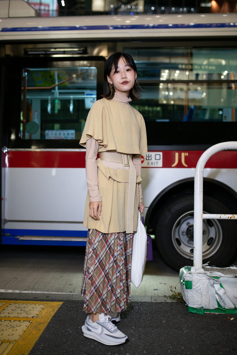 tokyo, japan   october 15 a guest is seen wearing beige dress, brown cross pattern skirt, white nike sneakers during the rakuten fashion week tokyo 2020 ss on october 15, 2019 in tokyo, japan photo by matthew sperzelgetty images