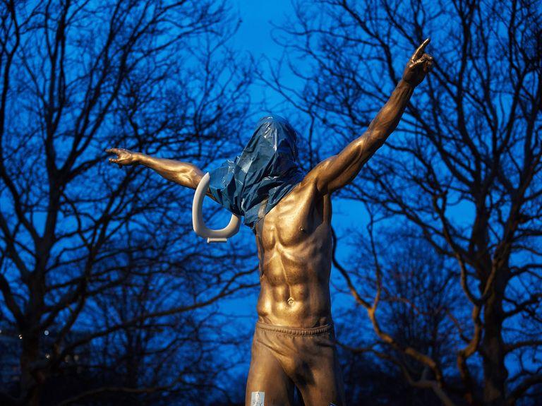 the statue of the swedish football player zlatan ibrahimovic covered in plastic and with a toilet seat on the arm is pictured in malmoe, november 27, 2019   the statue was set alight after ibrahimovic annonced the he have bought a share in the swedish stockholm based football team hammarby photo by andreas hillergren  various sources  afp  sweden out photo by andreas hillergrentt news agencyafp via getty images