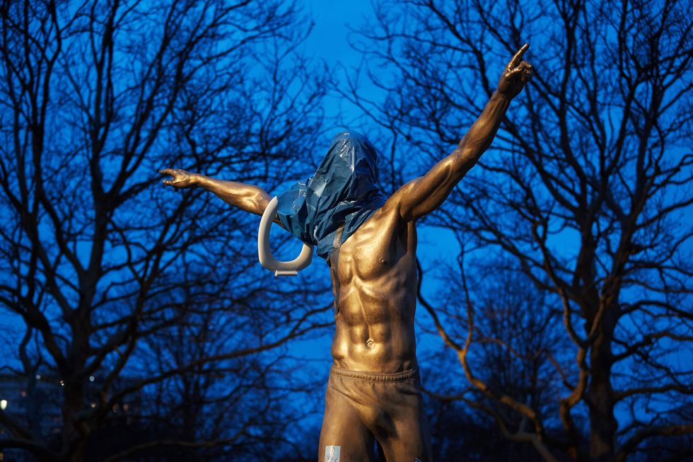 the statue of the swedish football player zlatan ibrahimovic covered in plastic and with a toilet seat on the arm is pictured in malmoe, november 27, 2019   the statue was set alight after ibrahimovic annonced the he have bought a share in the swedish stockholm based football team hammarby photo by andreas hillergren  various sources  afp  sweden out photo by andreas hillergrentt news agencyafp via getty images