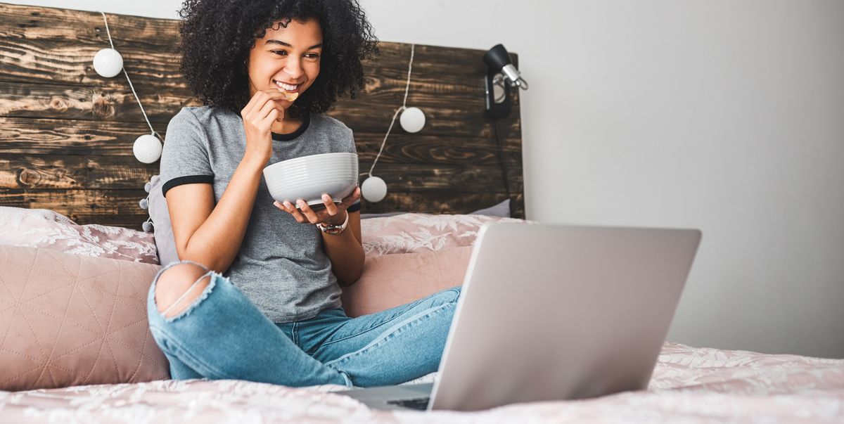 shot of a young woman using a laptop while sitting in her bedroom