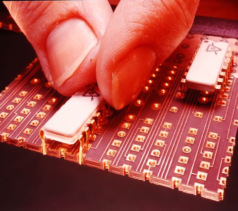 the process of inserting ibm computer chips into a circuit board in the united states, circa 1969