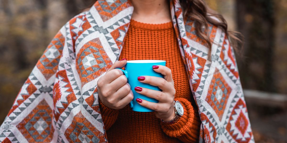 woman in autumn colors holding coffee mug