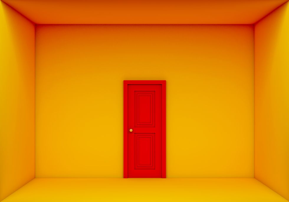 single red door closed on the yellow room