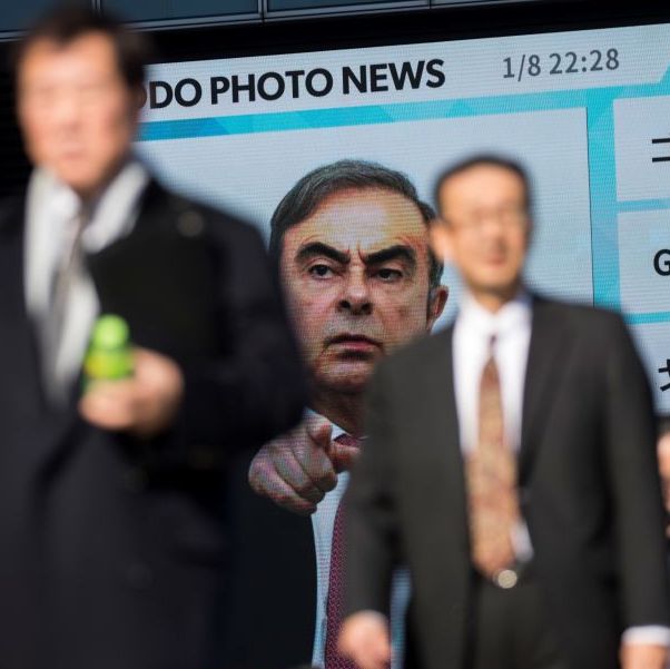 pedestrians pass by a huge screen showing a news program featuring former nissan chief carlos ghosn in tokyo on january 9, 2020   japans justice minister urged carlos ghosn to return and make his case in court, after the fugitive former auto tycoon gave an impassioned defence of his decision to jump bail and flee to lebanon photo by behrouz mehri  afp photo by behrouz mehriafp via getty images