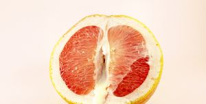 sexy grapefruit with sperm, erotic concept sectional grapefruit is a symbol of the vagina and clitoris