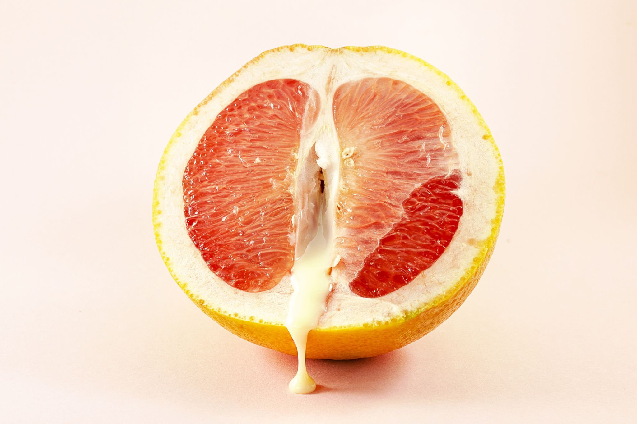 sexy grapefruit with sperm, erotic concept sectional grapefruit is a symbol of the vagina and clitoris