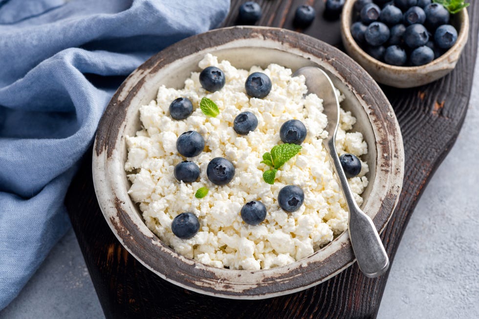 cottage cheese or curd with blueberries in bowl healthy food concept