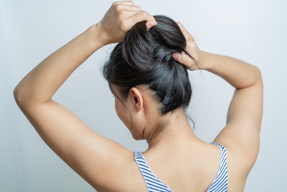 rear view of women tightening the hair, lifestyle concept