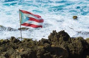 puerto rico flag on rocks near sea