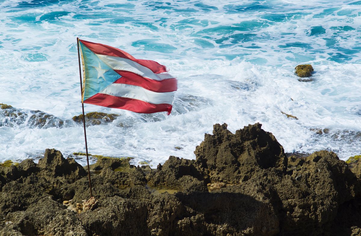 puerto rico flag on rocks near sea
