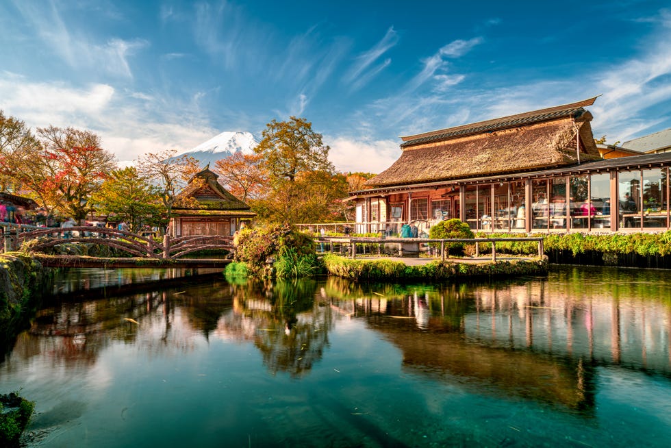 beautiful fuji mountain and pond reflection with traditional japanese style house at oshino hakkai in japan