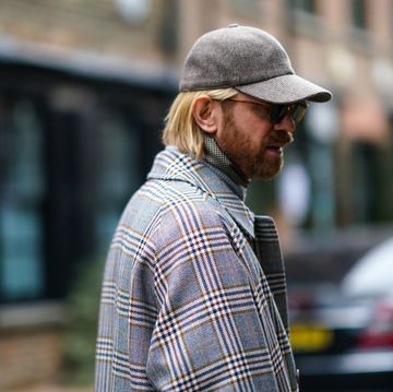 london, england   january 05 alistair guy wears a cap, sunglasses, a checked long coat, a scarf, during london fashion week mens january 2020 on january 05, 2020 in london, england photo by edward berthelotgetty images