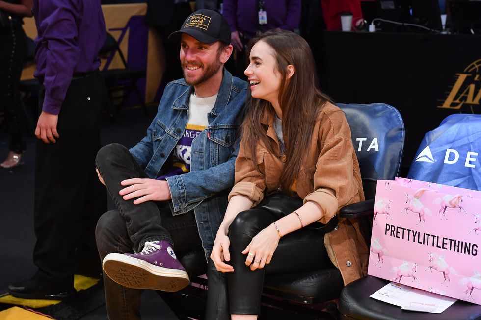 los angeles, california   january 13 lily collins and charlie mcdowell attend a basketball game between the los angeles lakers and the cleveland cavaliers at staples center on january 13, 2020 in los angeles, california photo by allen berezovskygetty images