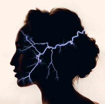 silhouette of woman with lightning in head