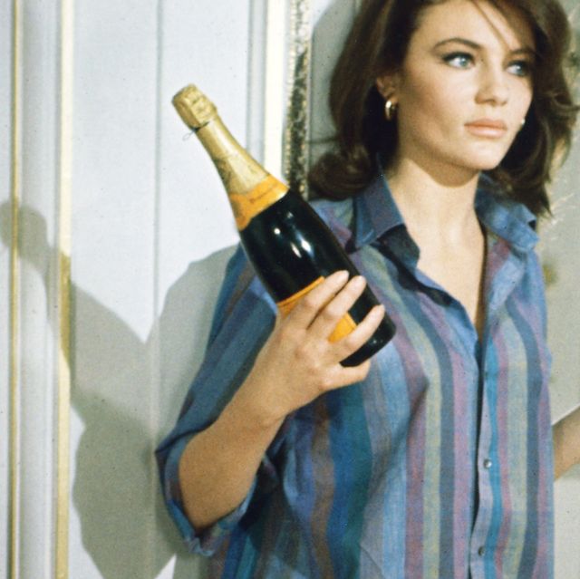 jacqueline bisset, british actress, wearing a shirt with vertical stripes, and holding a bottle of champagne and a champagne coupe, in a publicity still issued for the film, bullitt, 1968 the thriller, directed by peter yates 1929 2011, starred bisset as cathy photo by silver screen collectiongetty images